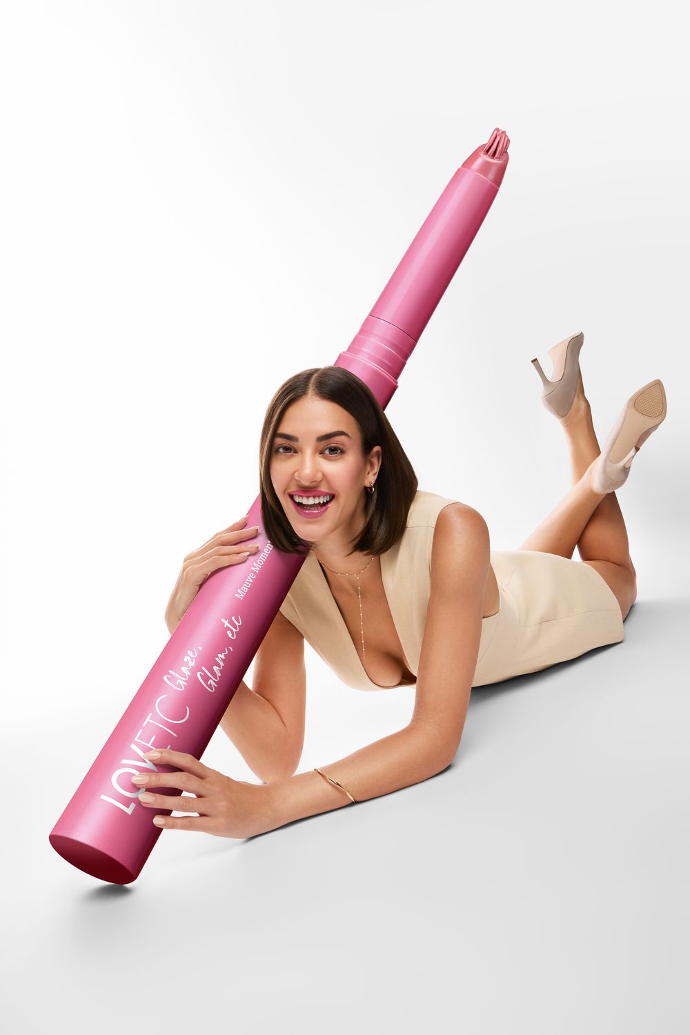 Model posed with an oversized LOVETC lip conditioner prop built for the campaign