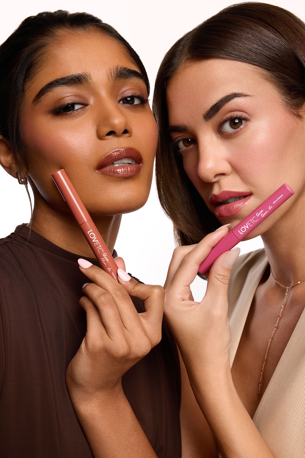 Two models holding two different LOVETC shades side by side
