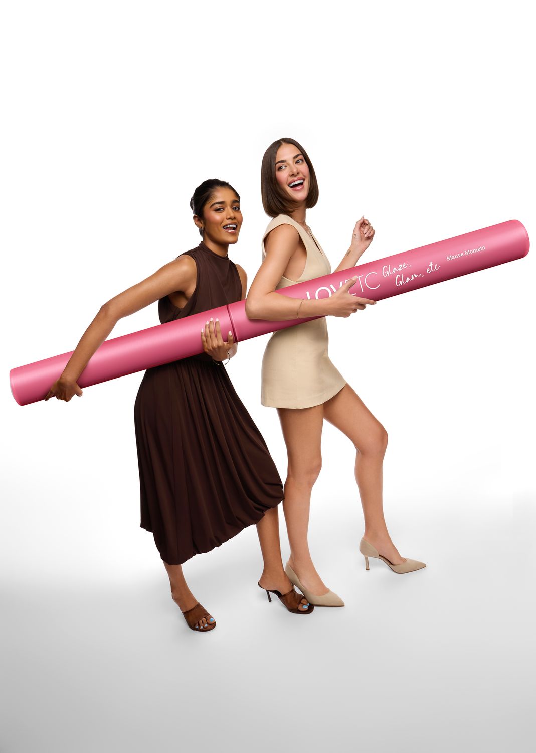 Two models carrying the oversized LOVETC lip conditioner prop